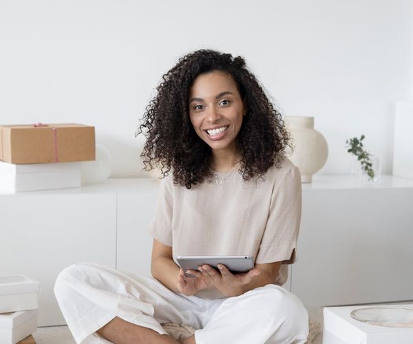 Portrait of a smiling woman in her 40s looking confident.